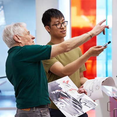 Faculty member and student reviewing work.