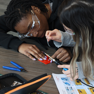  Students practice soldering a 3D printed low-profile adaptive switch in the Makers Making Change workshop.